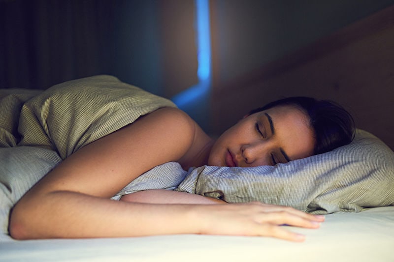 Shot of a young woman sound asleep in her bedroom