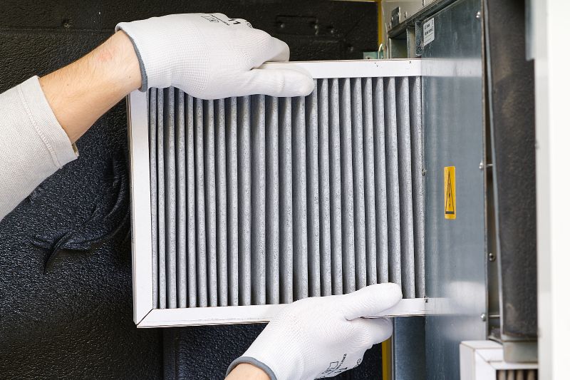 4 Reasons to Replace Your Home’s Air Filter - Technician Changes Air Filter.